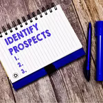 notebook with blue ink saying identifying prospects