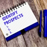 notebook with blue ink saying identifying prospects