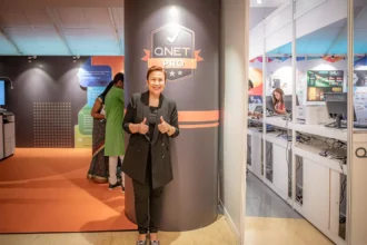 Ms Malou Caluza with QNETPRO logo