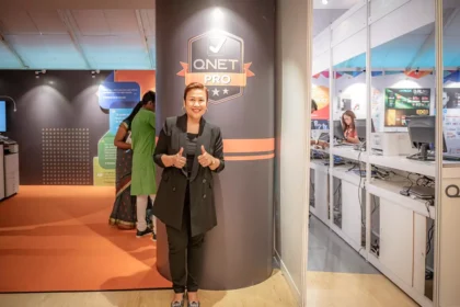 Ms Malou Caluza with QNETPRO logo
