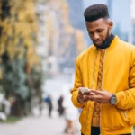 africanamericanstudentwalkingstreettalkingphone