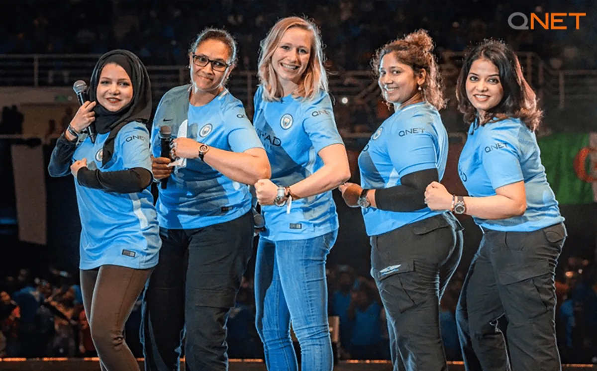 QNET standing with manchester city womens team