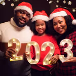 African family holding up a happy new year 2023 sign