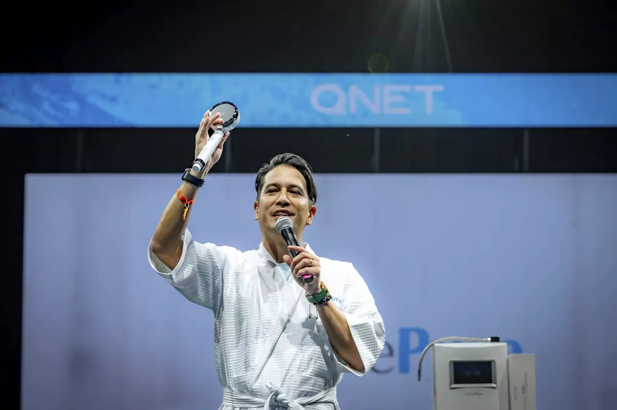 man on stage presenting
