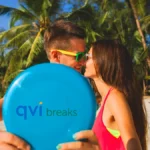 A couple enjoying they QVI Breaks holiday on the beach as they kiss