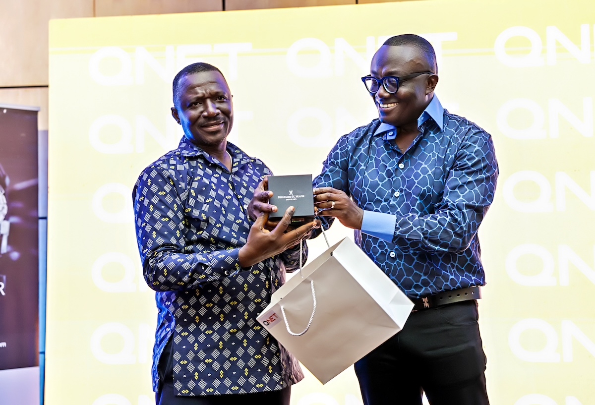 Bola Ray presenting a Bernhard H. Mayer watch at the QNET soiree in Ghana